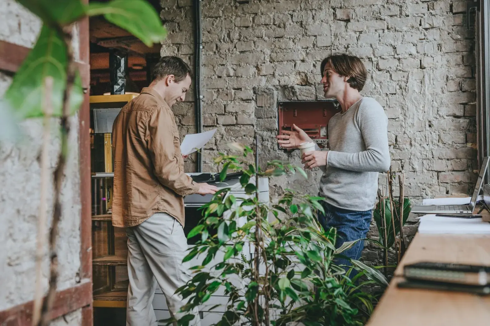 Two men talking with each other in an office space
