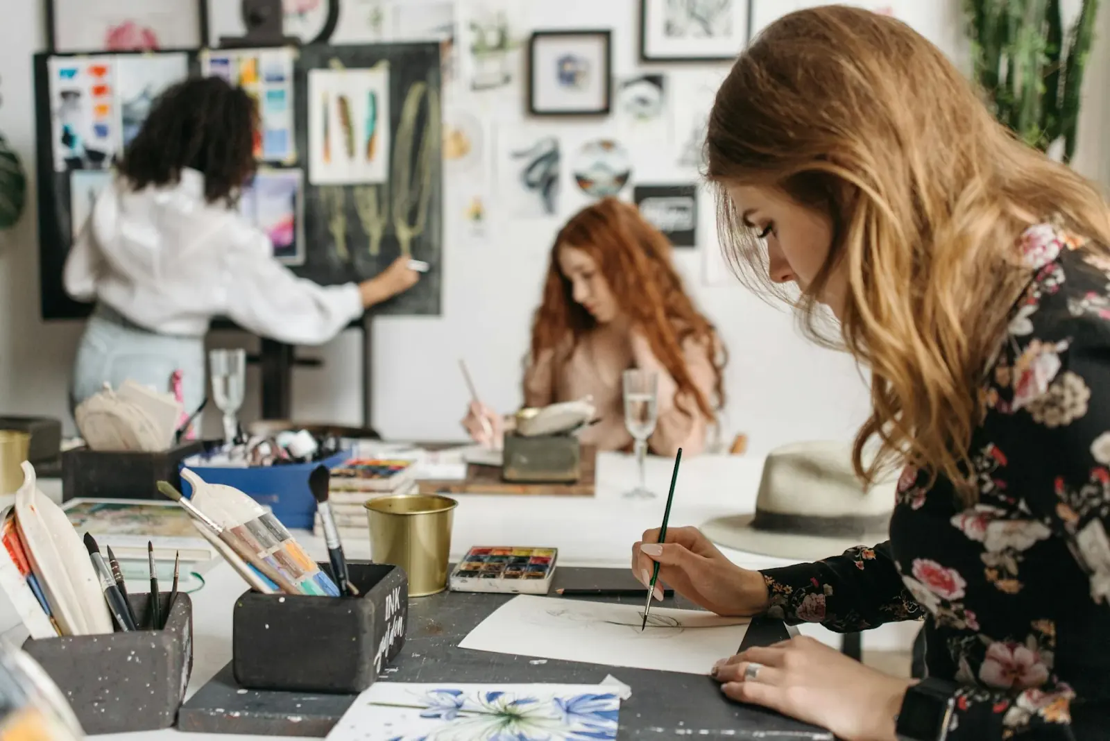 Three women in an art class or studio, painting